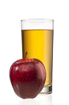 apple beside apple juice glass isolated on white background