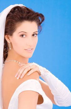 happy bride with her wedding ring over blue