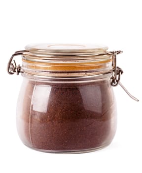 Glass jar with grinded coffee isoalted over white background