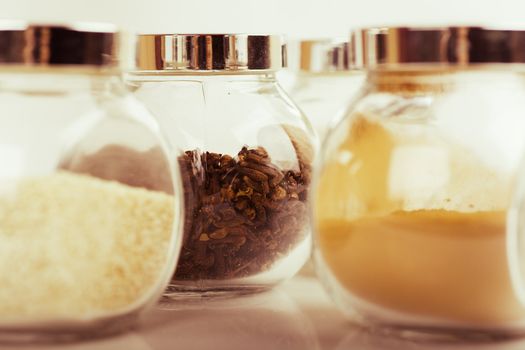 Closeup view of small glass jars with spices