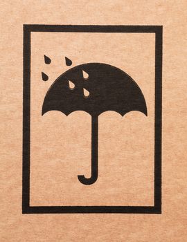 An umbrella sign on a cardboard box