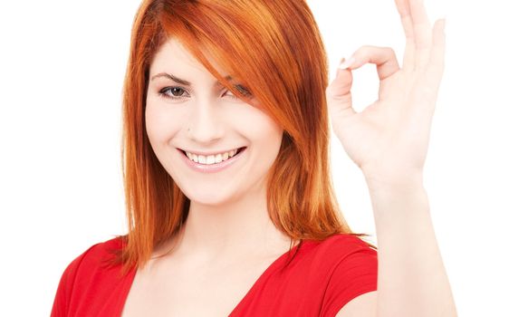 bright picture of lovely redhead showing ok sign