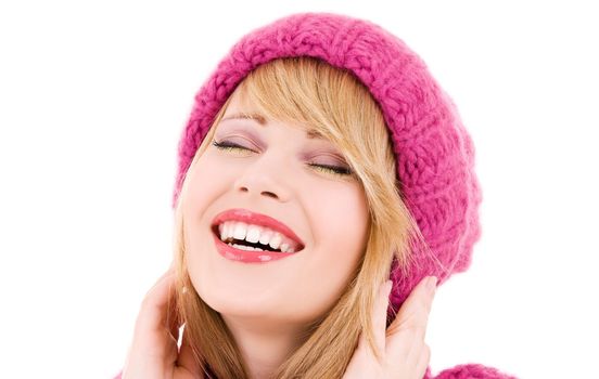 happy teenage girl in winter hat over white