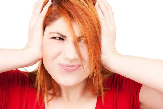 picture of unhappy redhead woman with hands on ears