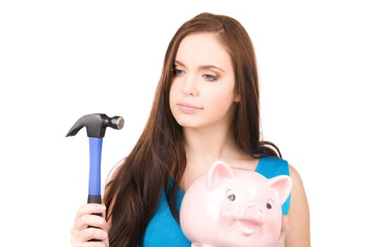 lovely teenage girl with piggy bank and hammer