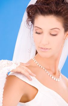 happy bride with her wedding ring over blue