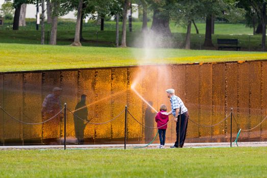 WASHINGTON DC - SEPTEMBER 16: Volunteers clean Vietnam Memorial wall on September 16, 2012. The Wall was completed by Maya Lin in 1982.