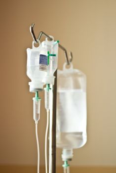 Three IV's hand on a stand in a hospital room