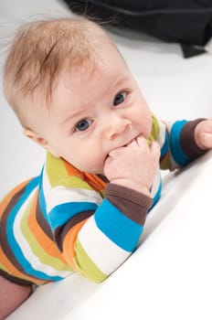 Shot of little baby lying on white background