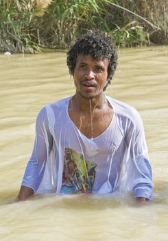 QASER EL YAHUD , ISRAEL - JAN 19 : Unidentified Ethiopian orthodox Christian man  participates in the baptising ritual during the epiphany at Qaser el yahud , Israel in January 19 2012