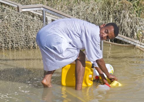 QASER EL YAHUD , ISRAEL - JAN 19 : Unidentified Ethiopian orthodox Christian man  participates in the baptising ritual during the epiphany at Qaser el yahud , Israel in January 19 2012