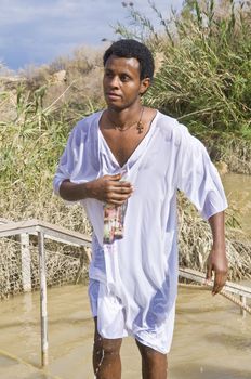 QASER EL YAHUD , ISRAEL - JAN 19 : Unidentified Ethiopian orthodox Christian man  participates in the baptising ritual during the epiphany at Qaser el yahud , Israel in January 19 2012