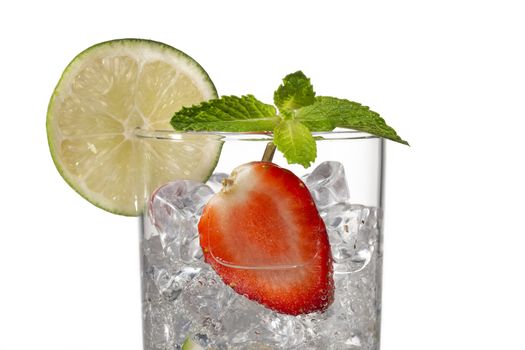 cropped image of a glass with ice cubes  strawberry slice and lemon