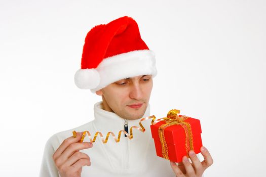 young man in a Santa hat holding a red Christmas gift