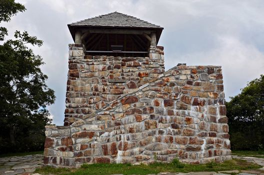 An old stone tower lookout area on top of Wayah Bald in North Carolina. It was used the the early 1900's and has the intersections of the Bartram Trail and the Appalachian Trail nearby. Wayah Bald has a vantage point 5,342 feet in elevation in the Nantahala National Forest, near Franklin, North Carolina. On a clear day, you can see north to the Great Smoky Mountains in Tennessee and south into the rolling hills of Georgia. It was listed on the National Historic Lookout Register in 2007.