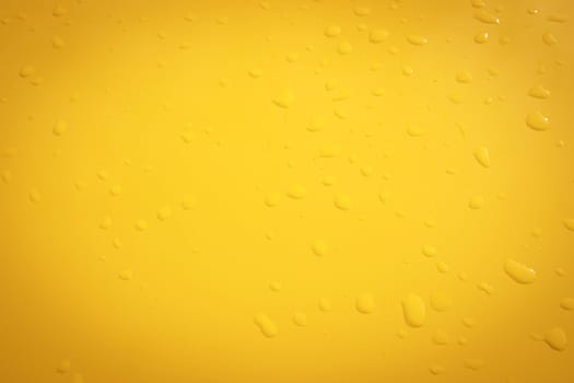 raindrops on the surface painted in yellow metal