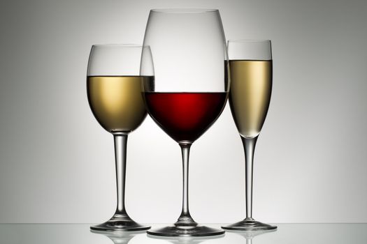 glass of red and white wine on a white background