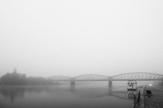 Prague railway bridge in early morning fog