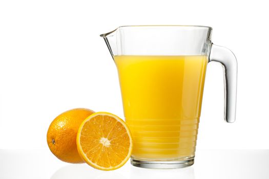 orange juice in jug on a white background