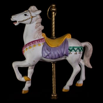 Colorful carousel horse isolated on black background