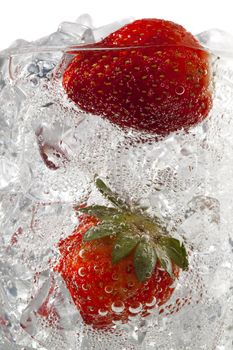 glass of ice cubes with strawberries
