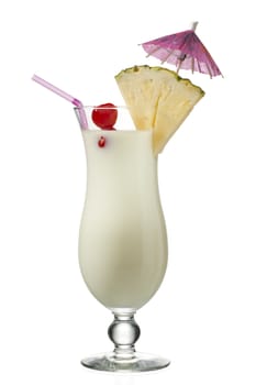 view of a pineapple milkshake with slice of a pineapple and a wooden umbrella