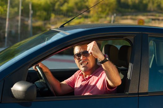 Macho driver sticking his fist out of the window