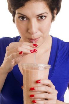 Beautiful woman with manicured nails sips a neutral colored smoothie