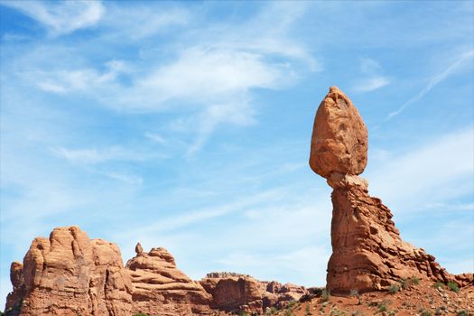 Arches National park balancing rock at during day against dramatic sky