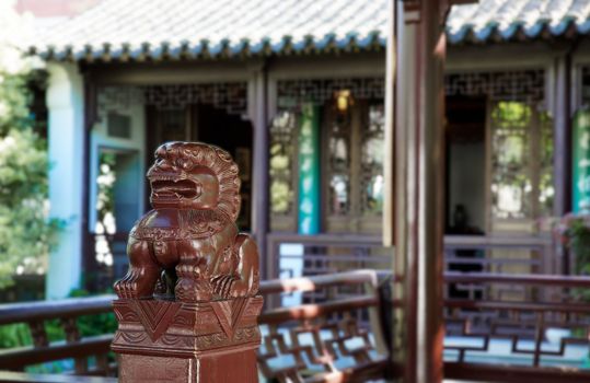 Guardian Foo Dogsculpture at a Chinese building with soft focus background