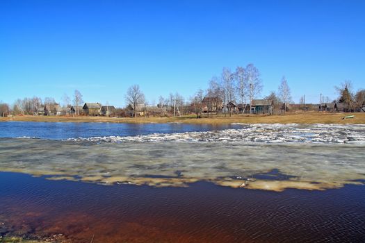 village on coast autumn river