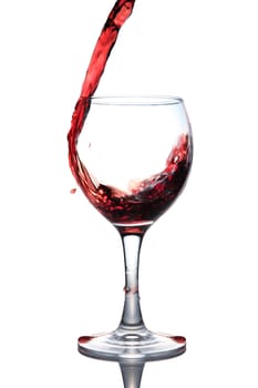 red wine pouring into glass isolated on white background 