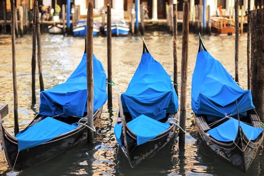 Three gondolas at sunset in Venice, Grand Canal, Italy. 