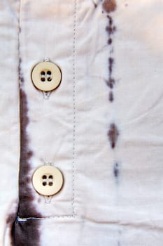 A part of a shirt with buttons