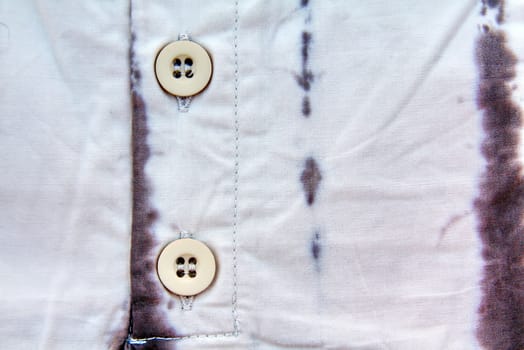 A part of a shirt with buttons