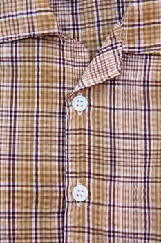 A part of a shirt with buttons
