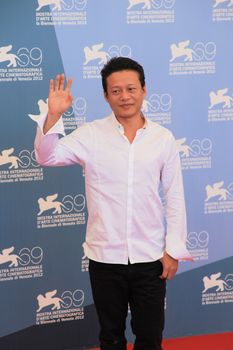 Lee Kang Sheng poses for photographers at 69th Venice Film Festival