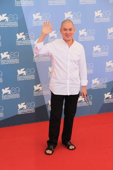 Ming Liang poses for photographers at 69th Venice Film Festival