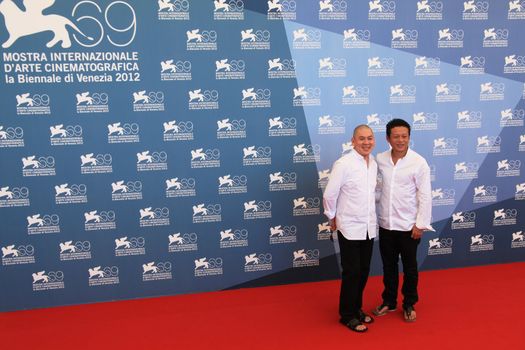 Ming Liang and Lee Kang Sheng pose for photographers at 69th Venice Film Festival