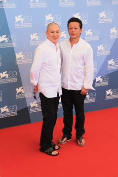 Ming Liang and Lee Kang Sheng pose for photographers at 69th Venice Film Festival