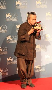 Kim Ki-duk poses for photographers at 69th Venice Film Festival