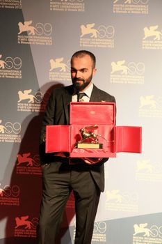Ali Aydin poses for photographers at 69th Venice Film Festival