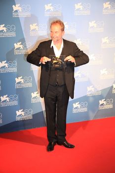 Ulrich Seidl poses for photographers at 69th Venice Film Festival