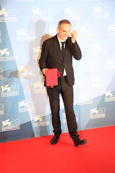 Olivier Assayas poses for photographers at Venice Film Festival