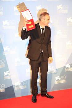 Olivier Assayas poses for photographers at Venice Film Festival