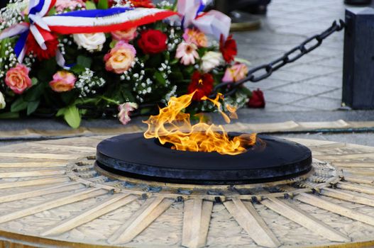 The flame of the unknown soldier under the Arc de Triomphe in Paris, France