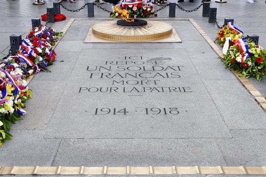 The flame of the unknown soldier under the Arc de Triomphe in Paris, France