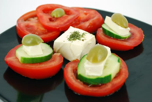 Decorative salad with cheese,olives,tomatoes and cucumber