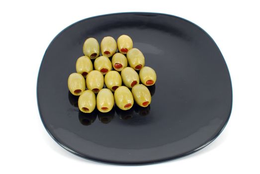 Olives on black dish isolated on white