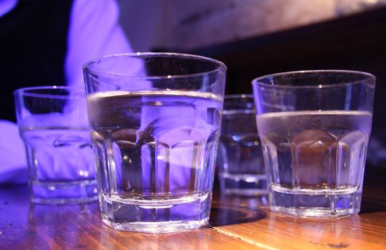 Drinking bout. Glasses with cold drink on the wooden table